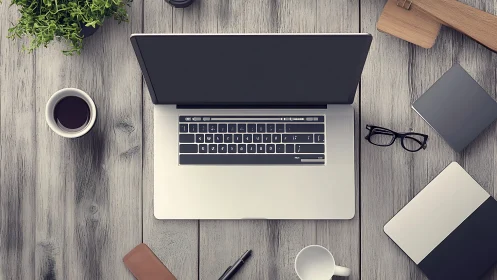 Open laptop on wooden desk surface with assorted work items