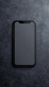 Modern smartphone on textured concrete surface.