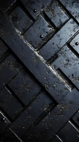 Weathered black metal plate grid shows corroded surface detail