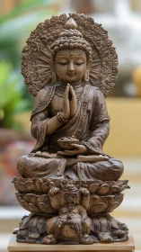 Seated Buddha statue on lotus pedestal with ornate halo.