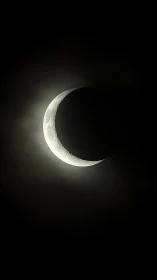 Crescent moon in high-contrast astro capture with soft halo.