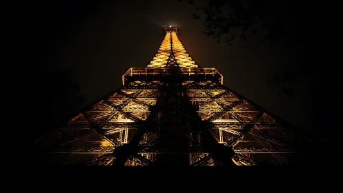 Illuminated lattice tower captured from low central viewpoint