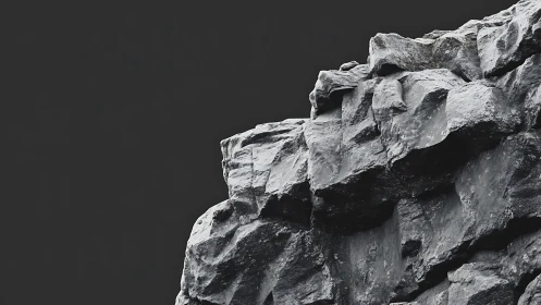 Sheer basalt cliff face against stark graphite sky backdrop.