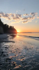Coastal headland and pebble shore at low tide sunset.