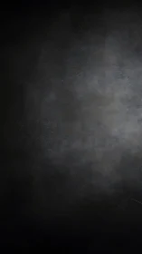 Textured dark vignette surface forms subtle radial light gradient