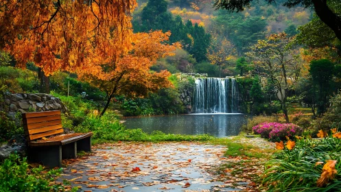 Park bench faces small waterfall across reflective autumn pond