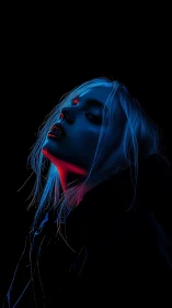 Neon blue portrait isolates tilted face in black void