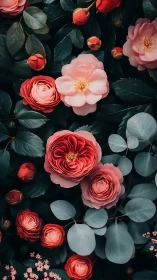 Garden arrangement with pink and coral camellia blooms.