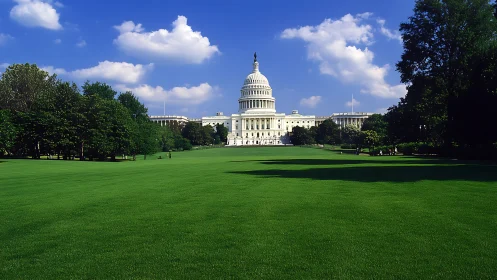 Sunlit Capitol building rises beyond a wide emerald lawn