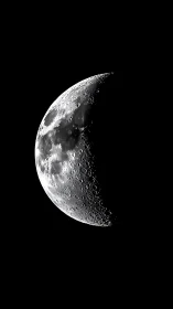 First quarter moon close-up with sharp crater relief.