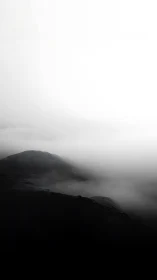 High contrast foggy ridgeline in minimal monochrome landscape