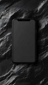 Mobile device positioned centrally on textured black marble surface