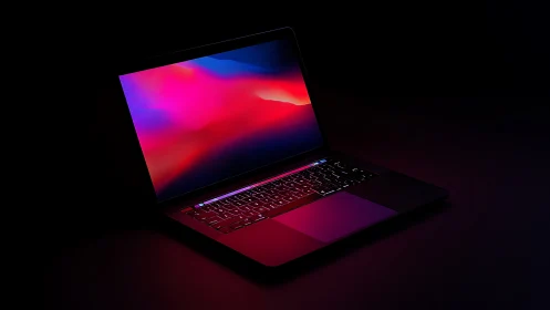 Midnight laptop glows like a portal to neon-tinted horizons