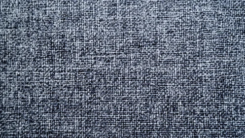 High-resolution gray woven fabric texture shows tight crossweave