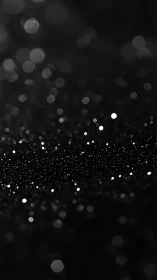 Out of focus white light bokeh dots scattered on black