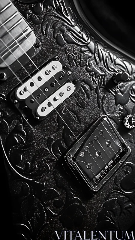 Embossed black electric guitar macro in dramatic side lighting.