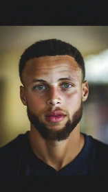 Warm portrait of focused young man with calm hazel eyes.