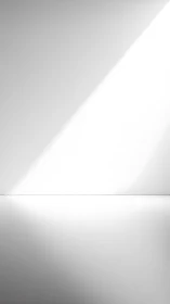 Diagonal light beam intersects minimalist horizon in soft grayscale
