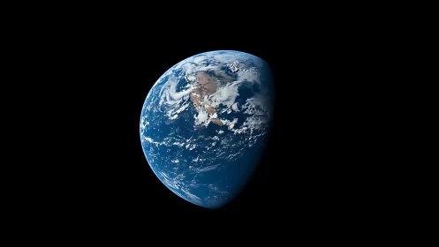 Earth in half-phase orbit framed by deep negative space.