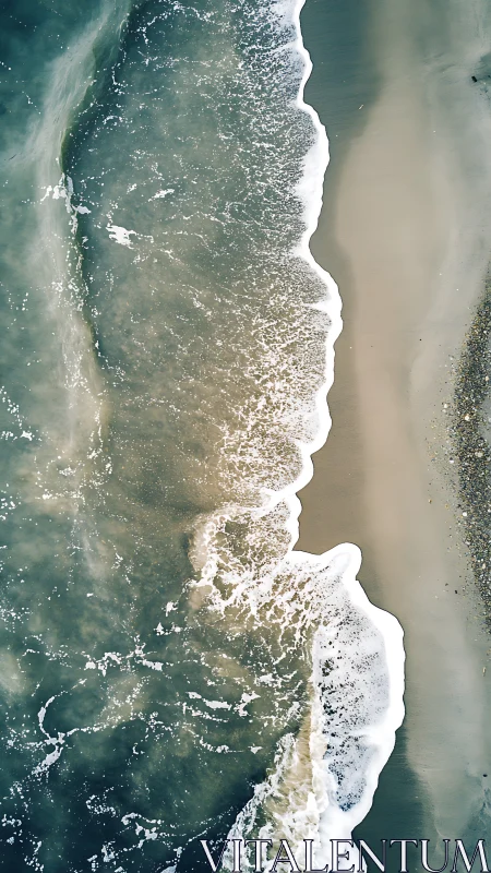 Vertical aerial view of shoreline with breaking sea waves.