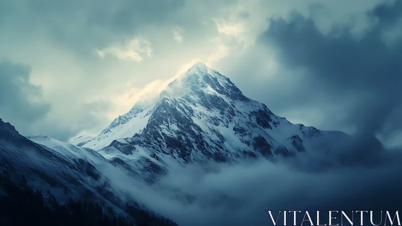 Snowlit mountain peak rising through soft stormy clouds.
