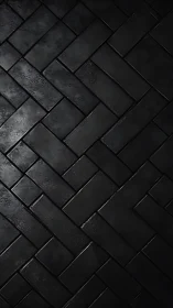Black rectangular tiles form a herringbone layout in close view