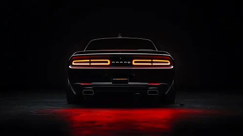 Muscle car rear silhouette glows with vivid red taillights.