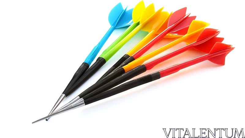 Colorful plastic darts lie fanned on white reflective surface