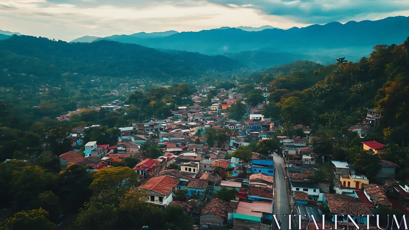 Mountain town skyline under misty blue ridgeline at dusk.