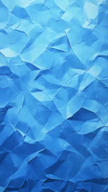 Crumpled blue paper surface with faceted abstract texture.