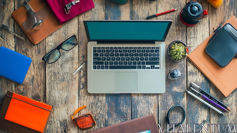 Overhead composition of laptop workspace on rustic wooden desk