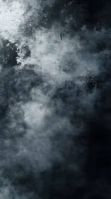 Dark textured abstract surface shows cloudlike gray gradients