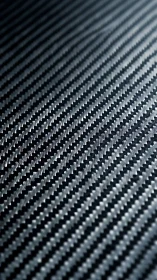 Carbon fiber weave macro with diagonal high-contrast pattern.