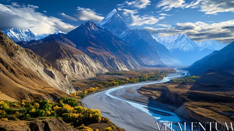 Snow crowned mountains watch over a calm winding river valley