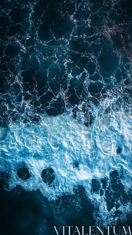 Turbulent teal ocean waves crash in foaming aerial view