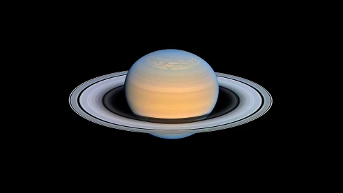 Saturn ring system glows in high-contrast deep space view.