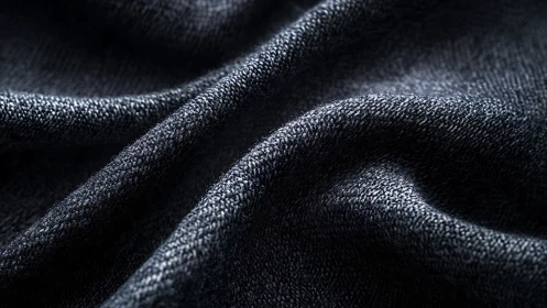 Luxurious Dark Fabric Folds: A Tactile Close-Up Experience.