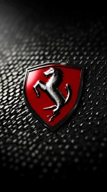 High-gloss prancing horse emblem on textured dark surface