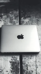 Quiet laptop moment on a weathered wooden worktable.