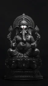 Monochrome seated Ganesha idol with ornate headdress detail.