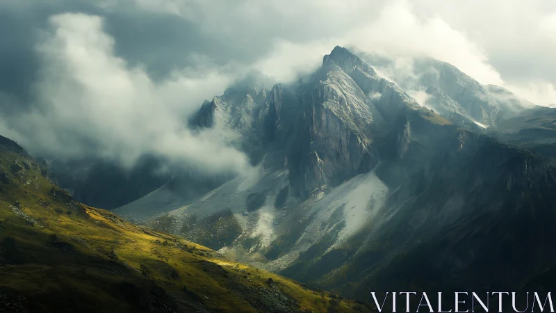 Dramatic rocky mountains rising through low heavy clouds.