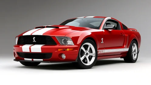 Red Shelby GT500 coupe on neutral studio backdrop.