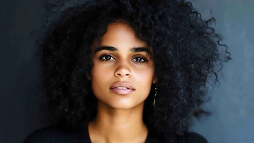 Confident woman with natural curly hair in a modern portrait.