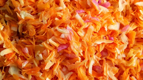 Closeup of shredded orange and pink flower petals mix.