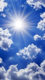 Direct sunburst in blue sky with scattered cumulus clouds.