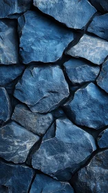 Moody blue stone wall with layered rugged texture detail.