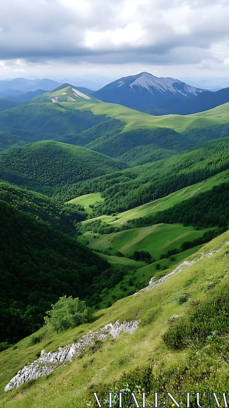 Layered green mountain valleys under dense cloud cover.
