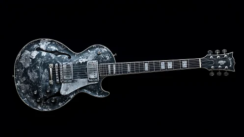 Electric guitar with distressed finish shown on black background
