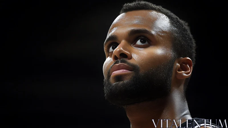 Focused basketball player under dramatic arena lighting.