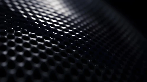 Close-up of Perforated Metal Surface with Dramatic Lighting.